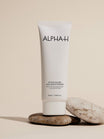 Alpha-H After Hours AHA Moisturiser op een stapel stenen