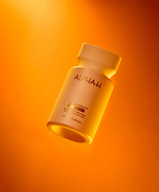 Alpha-H Liquid Gold + Vitamin C Exfoliating Treatment flacon in oranje licht