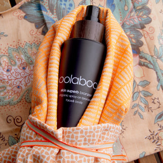 Oolaboo Skin Superb Organic Spray-on Bronzer in een oranje doek